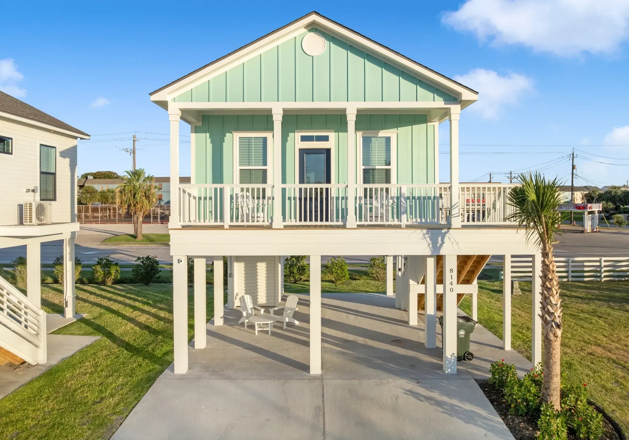 Elevated beach house with front porch.